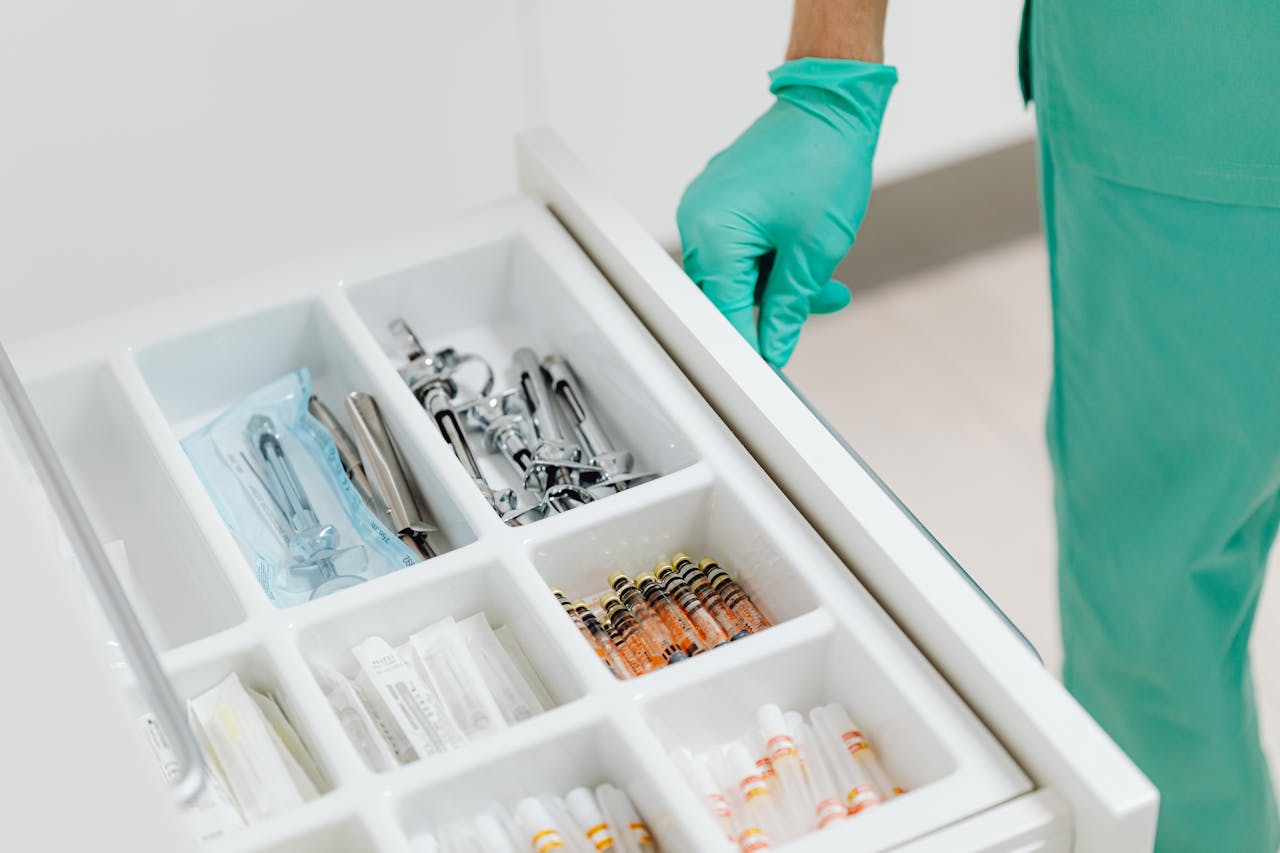 Sterile drawer with medical instruments and syringes in a clinic setting.